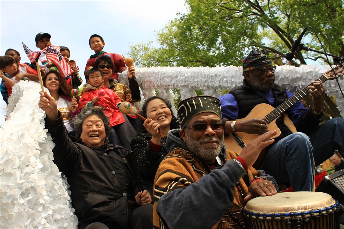 Community members ride on a float during a Juneteenth parade.