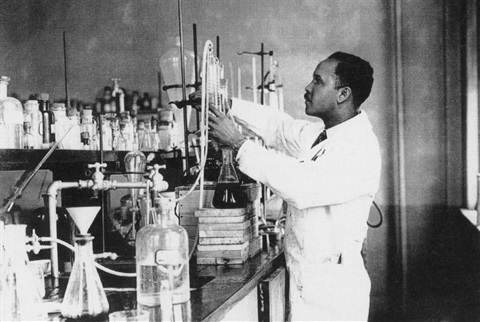 Dr. Percy L. Julian works in a laboratory.